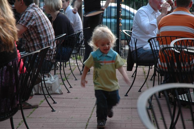 Claes running on patio at Momocho